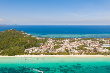 Fototapeta premium White beach on the island of Boracay, Philippines, top view. White sandy beach and turquoise sea water in sunny weather. Residential development and many hotels in Boracay.