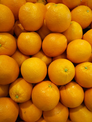 Fresh oranges that are placed on the shelves in the supermarket