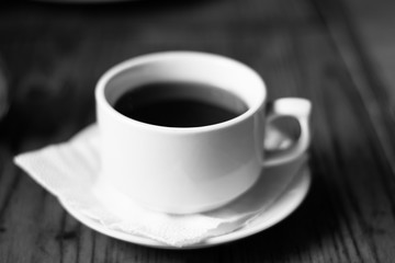 A cup of coffee tea in a cafe black and white photo