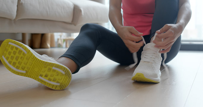 Woman Wearing Sport Shoes At Home