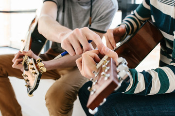Learning to play the guitar. Extracurricular activities or tutoring or hobbies or creative...