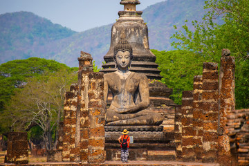 Sukhothai historical park with Asian traveller walking on the temple, this image can use for...