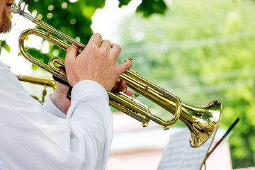 The musician plays the trumpet during an outdoor concert_