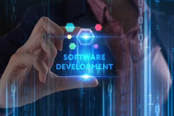 The concept of business, technology, the Internet and the network. A young entrepreneur working on a virtual screen of the future and sees the inscription: Software development