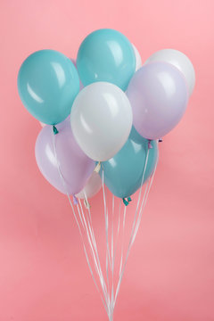 White, Blue And Purple Party Balloons On Pink Background