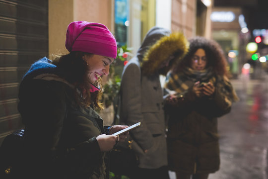 group of young  women using smartphone outdoor