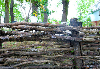 Wicker wooden fence in the village