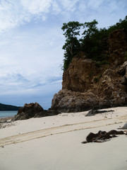 Large rock cliffs on the beach On the sky and clouds background