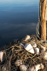 Nets, fishing equipment That was placed beside the wooden pillars On the sea background