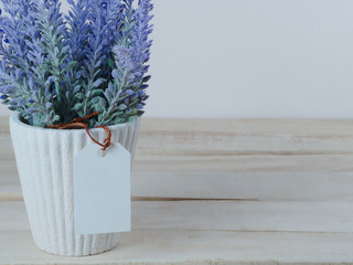 Purple lavender pots, with blank paper tags And put on a wooden table For the background