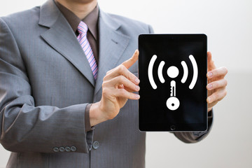 Businessman using tablet with icon graphic cyber security wifi network of connected devices and personal data information