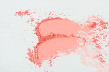 Eye shadow or bronzer pink smudge on white background.