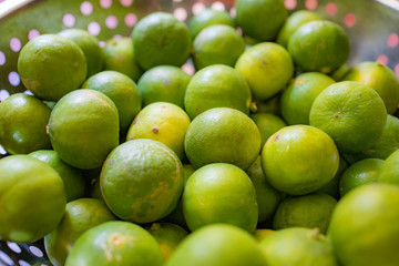 Focus and Blur on Green lemon lime or Thailand lemons on metal basket. Abstract of sweet, sour flavor and Thirsty.