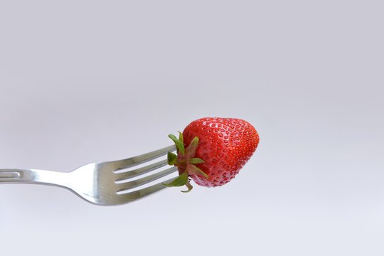 bold strawberries on a fork