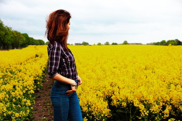 Fototapeta premium young woman in a rape field