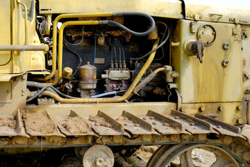 Engine parts of the old agricultural tractor with rusty pipes. Tractor motor compartment, tractor motor, internal part of tractor. Old Diesel engine.