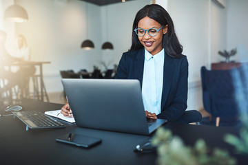 Smiling young African American businesswoman working in a modern