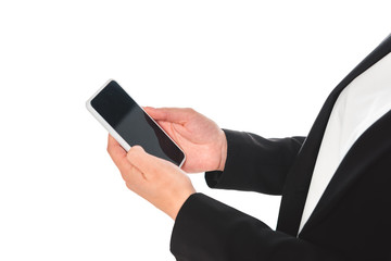 partial view of businesswoman holding smartphone with blank screen isolated on white