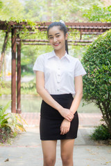 Fototapeta premium Portrait of thai adult student university uniform beautiful girl relax and smile