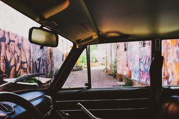 Street with graffiti on the walls of the car interior