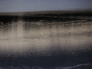 Sky reflection on the calm lake water surface