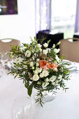 The composition of fresh flowers on the table. The decor of the Banquet in the restaurant flowers. Selective focus.