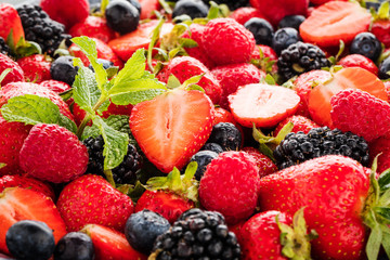 close-up view of fresh strawberries, blackberries and blueberries