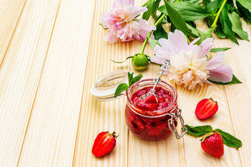 Obraz na płótnie Canvas Strawberry jam in a glass jar.