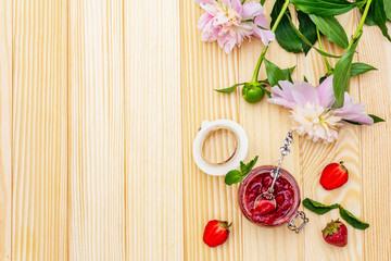 Strawberry jam in a glass jar.