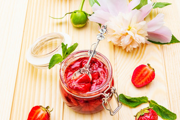 Strawberry jam in a glass jar.