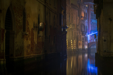 Reflection of streetlights in one of canals in Venezia, Italy