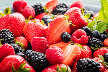 close-up view of fresh strawberries, blackberries and blueberries