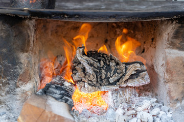 Traditional way of making food on open fire in old Indian kitchen in a village Pushkar, Rajasthan,...