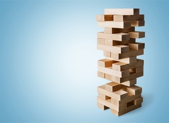 Wood blocks stack game with Hand on background,Conceptual of Teamwork, Strategy and Vision.