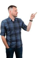 friendly young man pointing to his side and looking into the camera. isolated on white background