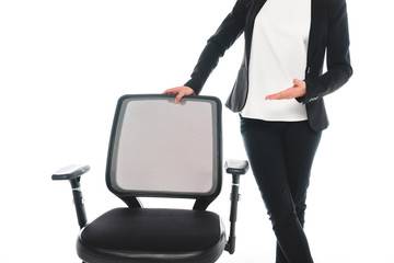 cropped view of businesswoman pointing with hand at office chair isolated on white