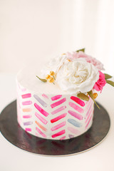 Cake with pink stripes and floral decorations