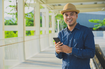 Young asian man using smartphone.