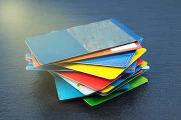 Stack of bank cards on a black background.