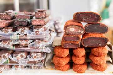 Variety of smoked and fried meat products. Traditional marketplace.