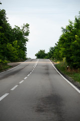 View from driving position through the window on empty road.