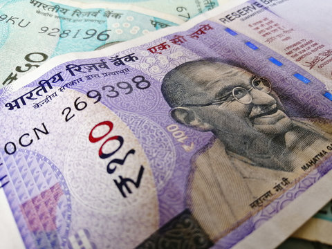 Indian currency two thousand one hundred rupee note and coins