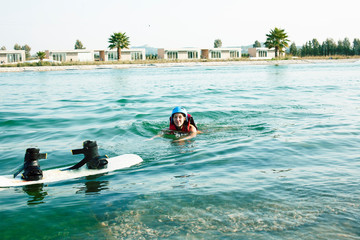 young smiling girl on wake board in water, happy lifestyle people on vacations