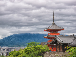 Ancient wooden temple with spring foliage colors at the mountain of Arashiyama, Kyoto, Japan.
