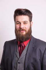 Young bearded man in stylish clothes over white background
