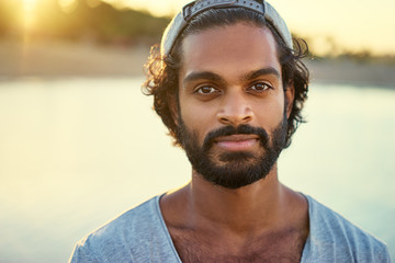 Handsome and confident. Outdoor portrait of smiling young african man on the beach.