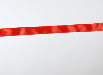Fototapeta premium red satin ribbon on white background