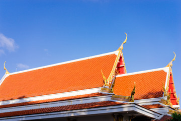 Fototapeta na wymiar Architecture and religion. Red roof top of thai buddhism temple.