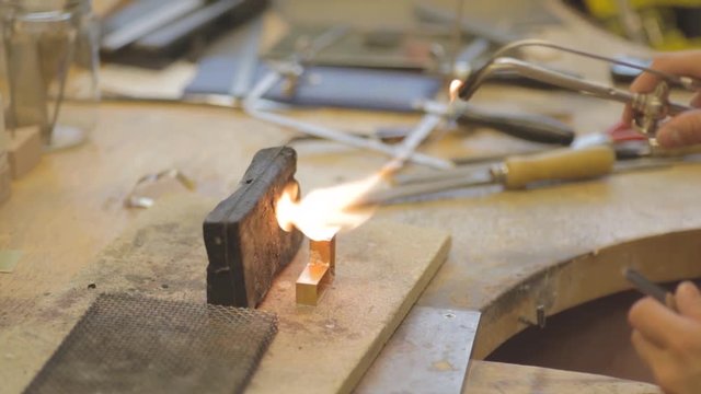 Close-up of female goldsmith working on jewlery