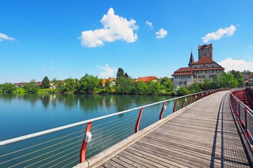Wooden footbridge over Aare river, view of Aarwangen Castle, Canton Berne, Switzerland. Idyllic...